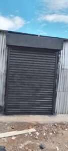 Heavy-duty steel roller shutter securing warehouse entrance in kenya east africa