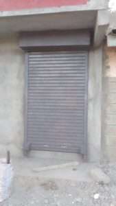 Heavy-duty steel roller shutter securing warehouse entrance in kenya east africa